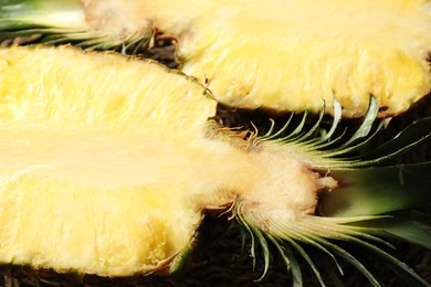 Photo of Halves of ripe pineapple on table, closeup