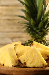 Photo of Cut fresh ripe pineapple on table, closeup