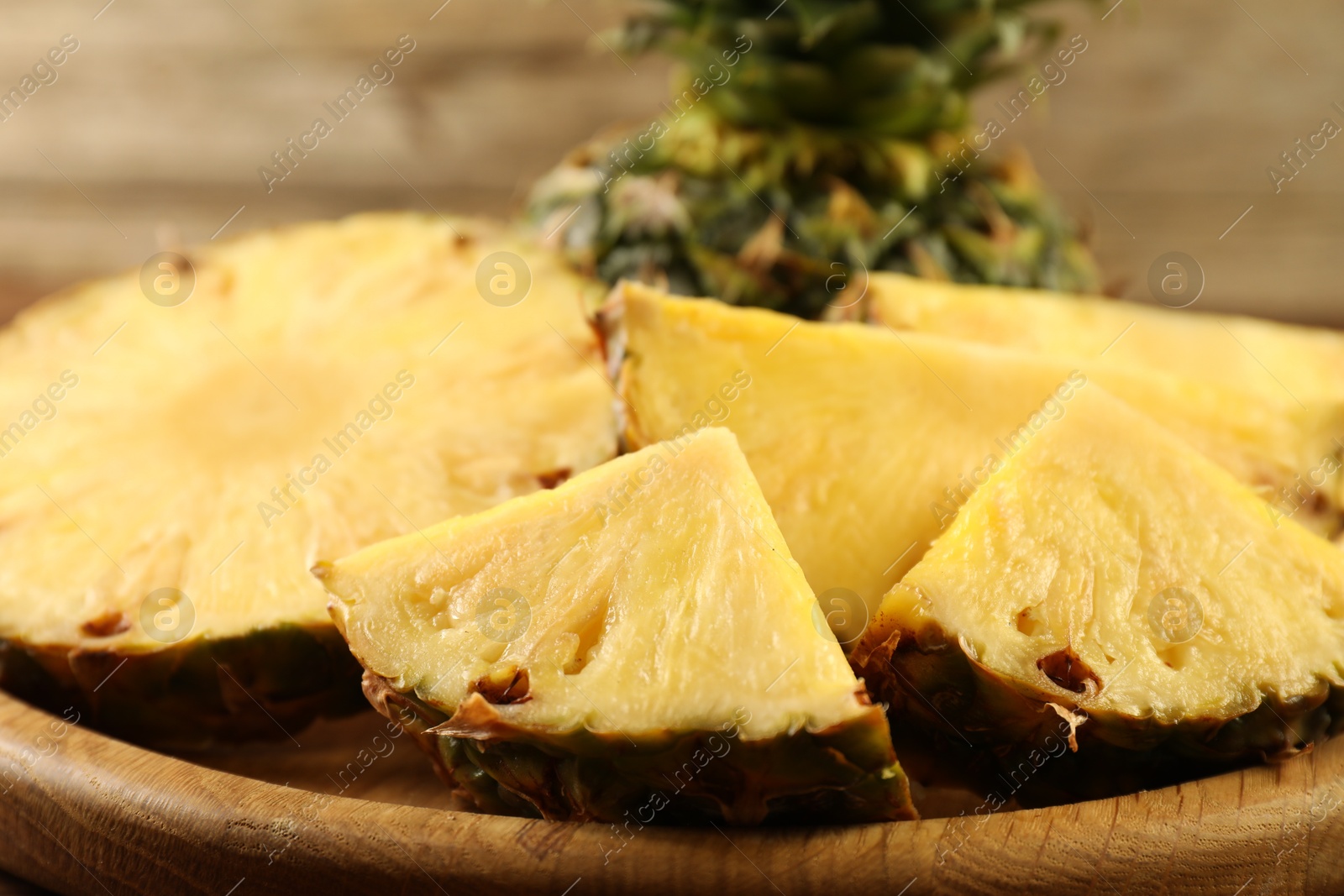 Photo of Cut fresh ripe pineapple on table, closeup