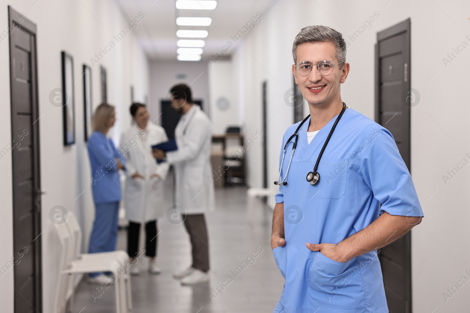 Photo of Healthcare workers in hospital, selective focus. Portrait of smiling nurse indoors