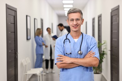 Healthcare workers in hospital, selective focus. Portrait of smiling nurse indoors