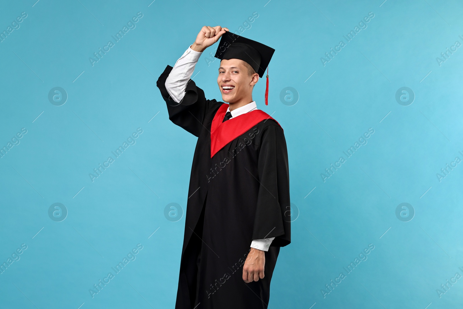 Photo of Happy student after graduation on light blue background