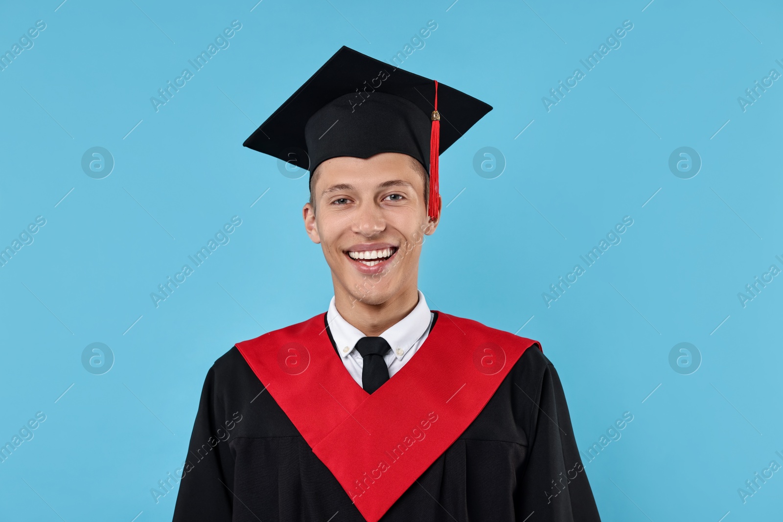 Photo of Happy student after graduation on light blue background