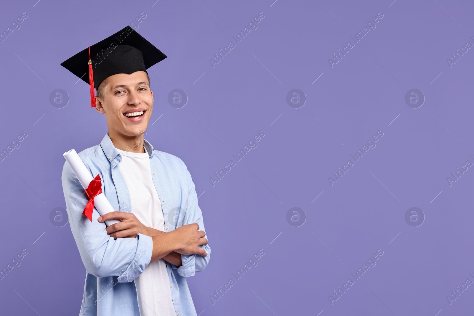 Photo of Happy student with diploma after graduation on violet background. Space for text