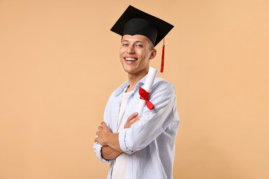 Photo of Happy student with diploma after graduation on beige background