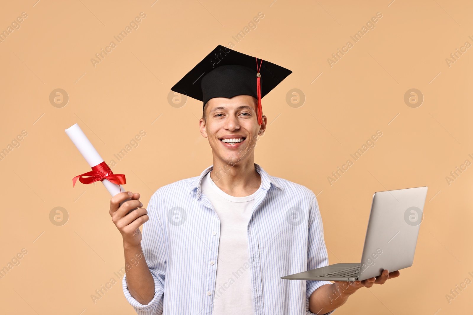 Photo of Happy student with diploma and laptop after graduation on beige background