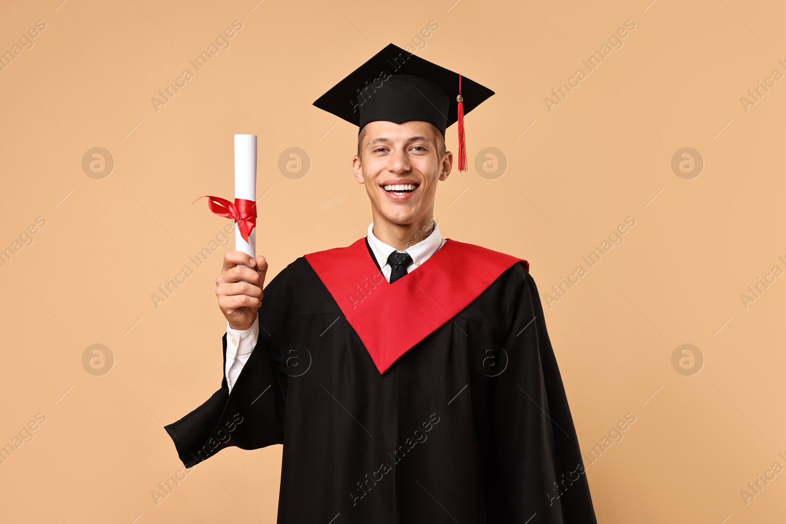 Photo of Happy student with diploma after graduation on beige background