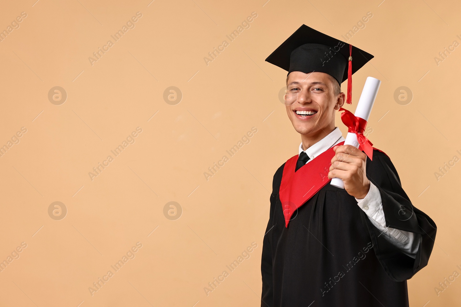 Photo of Happy student with diploma after graduation on beige background. Space for text