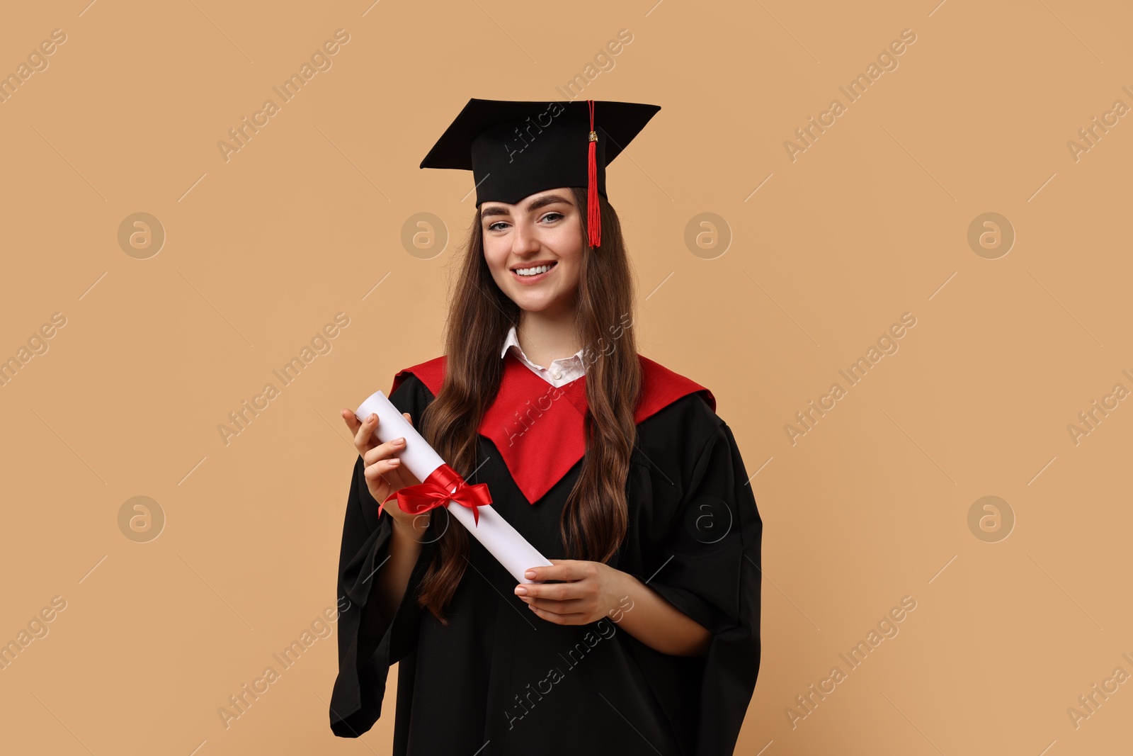 Photo of Happy student with diploma after graduation on beige background