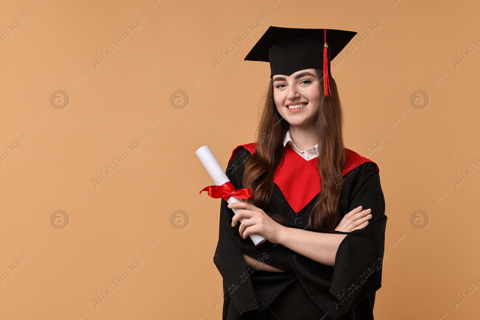 Photo of Happy student with diploma after graduation on beige background. Space for text