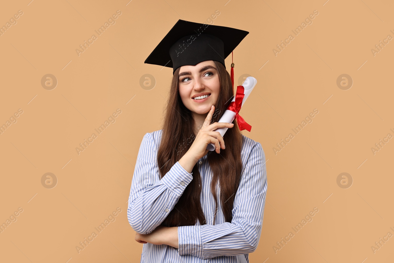 Photo of Happy student with diploma after graduation on beige background