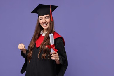 Photo of Happy student with diploma after graduation on violet background. Space for text