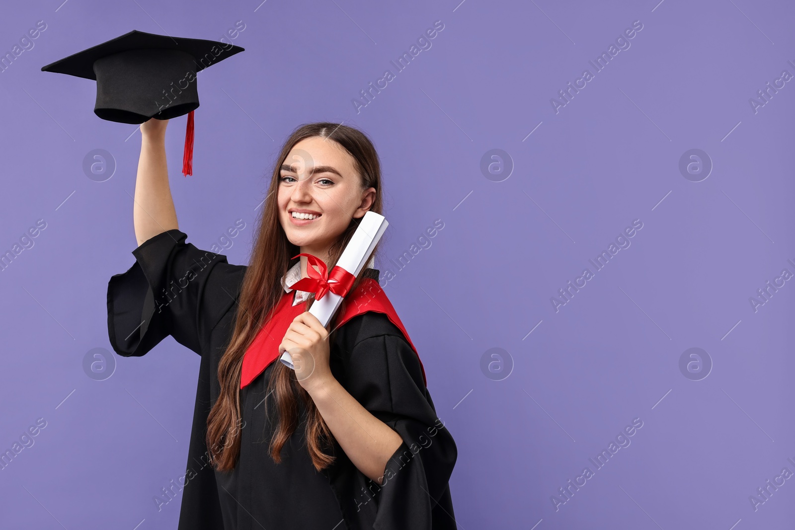 Photo of Happy student with diploma after graduation on violet background. Space for text