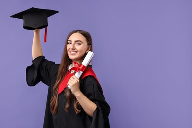 Photo of Happy student with diploma after graduation on violet background. Space for text