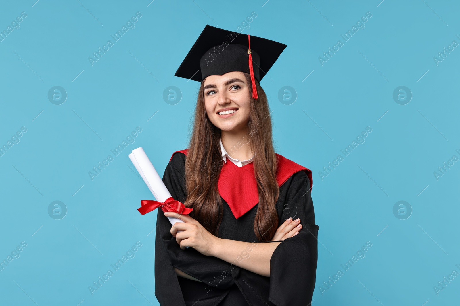 Photo of Happy student with diploma after graduation on light blue background