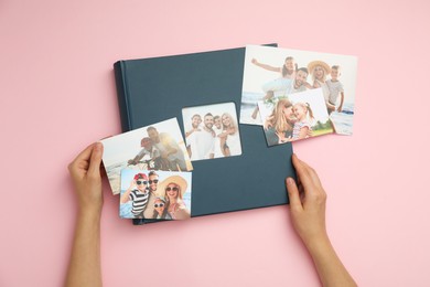 Woman with photo album and different photos on pink background, top view