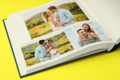 Photo of Open photo album with different photos on yellow background, closeup