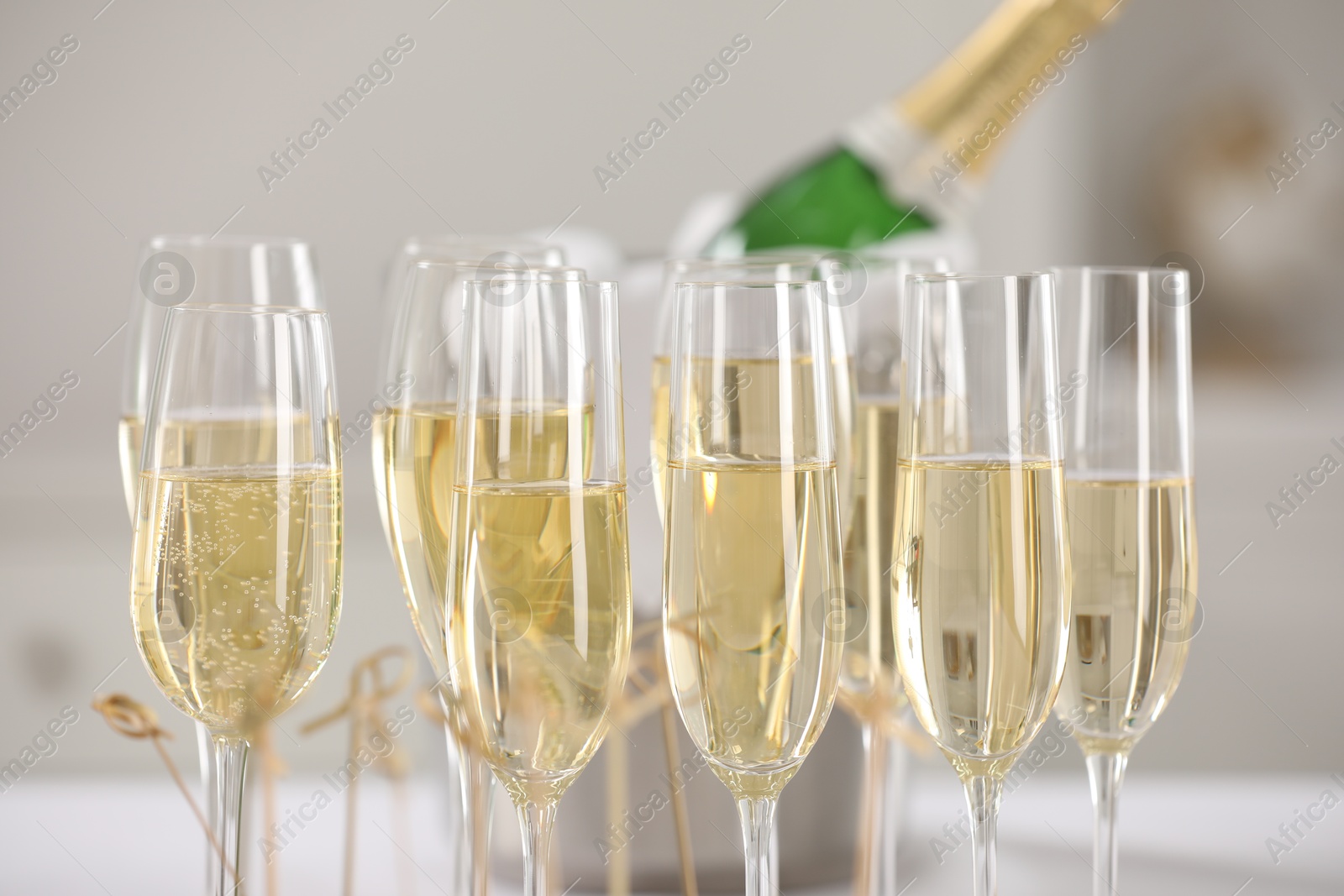 Photo of Champagne in glasses on blurred background, closeup