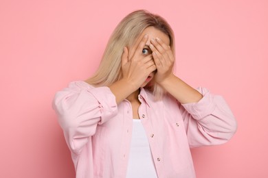 Photo of Portrait of scared woman on pink background