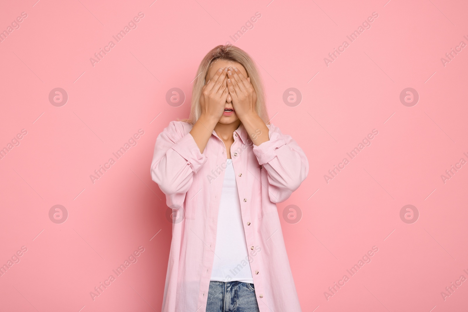 Photo of Portrait of scared woman on pink background