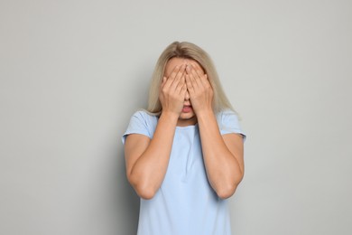 Photo of Portrait of scared woman on gray background