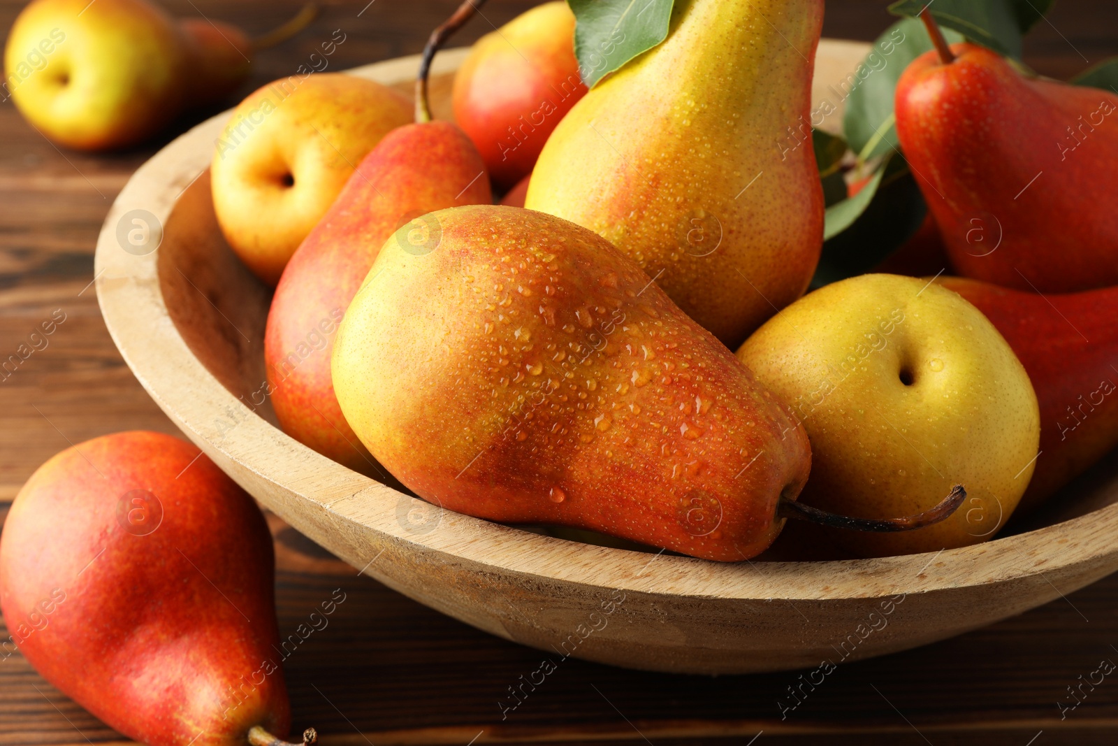 Photo of Ripe juicy pears on wooden table, closeup