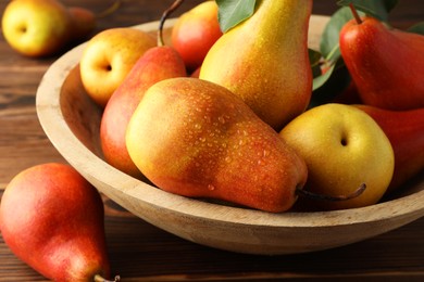 Photo of Ripe juicy pears on wooden table, closeup