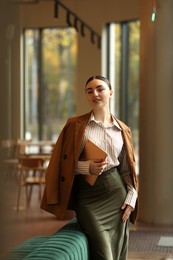 Photo of Woman in stylish formal suit with tablet indoors