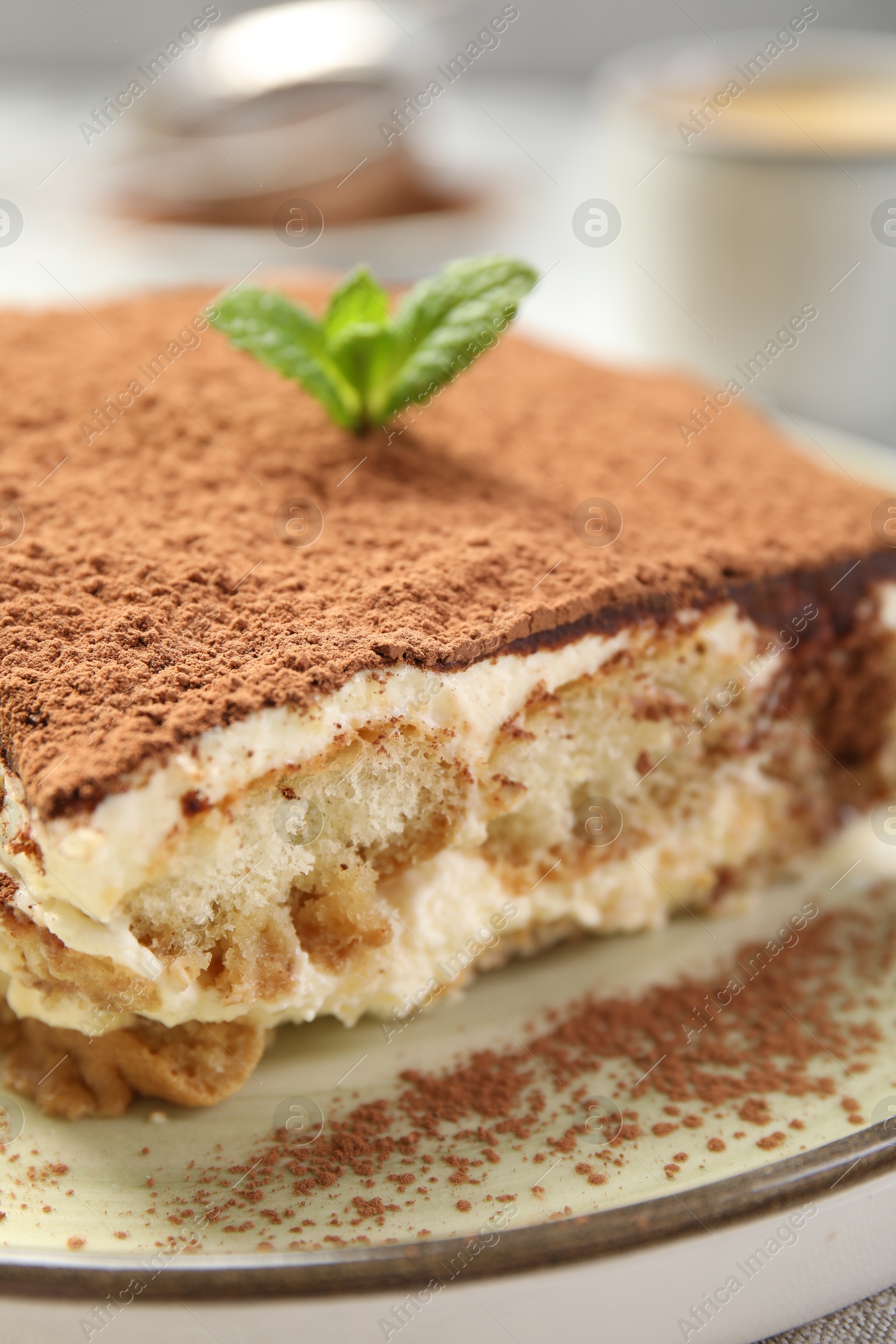 Photo of Piece of tasty tiramisu on table, closeup