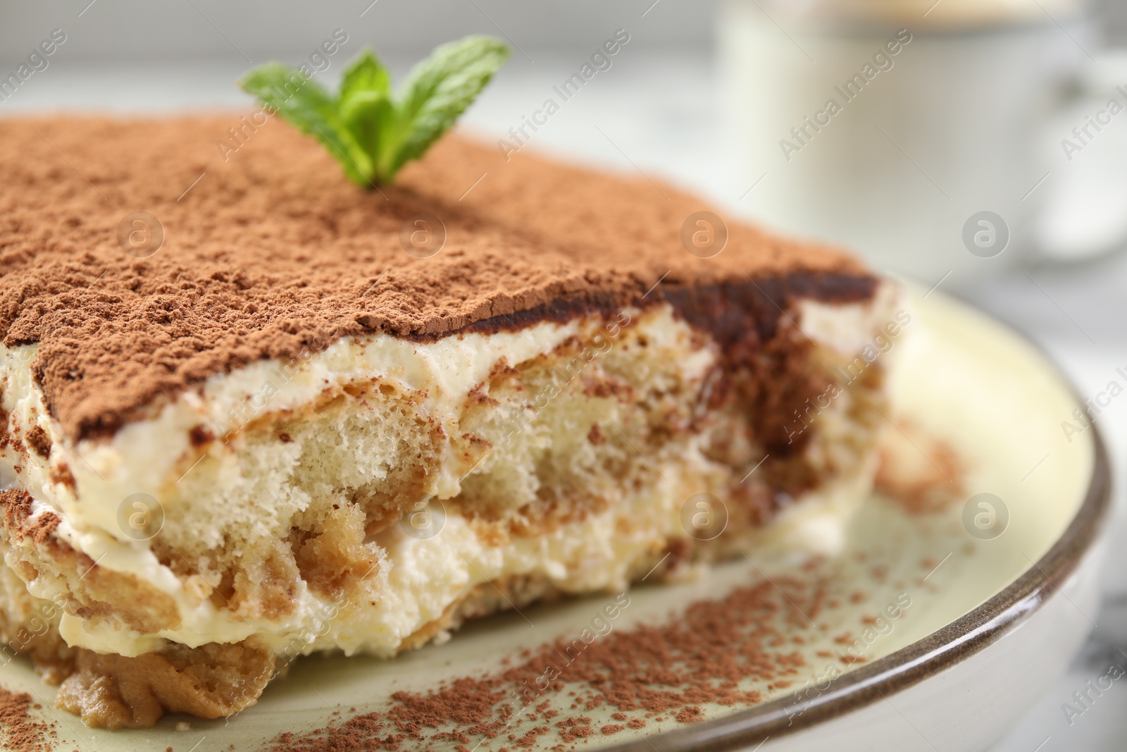 Photo of Piece of tasty tiramisu on table, closeup