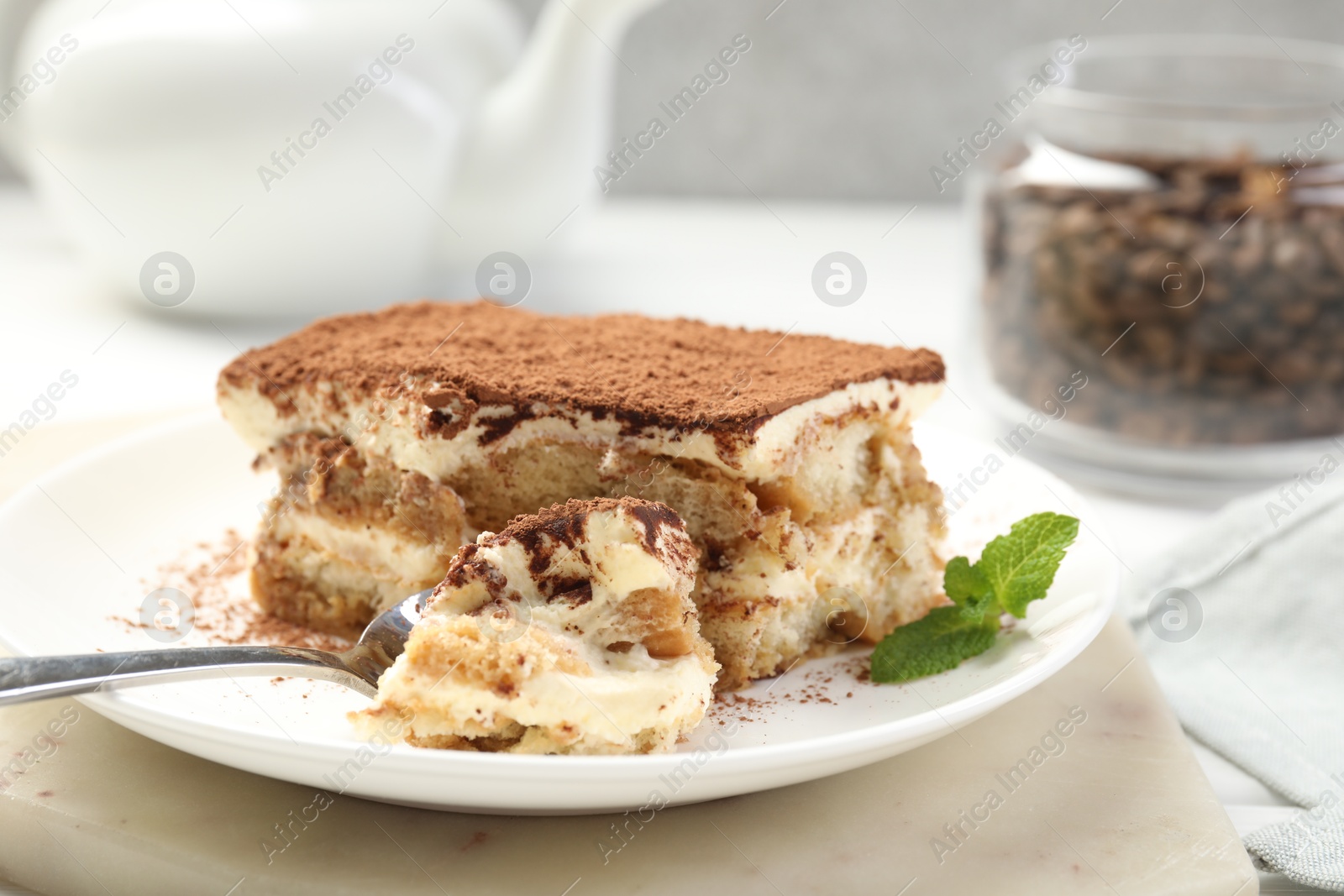 Photo of Piece of tasty tiramisu on table, closeup