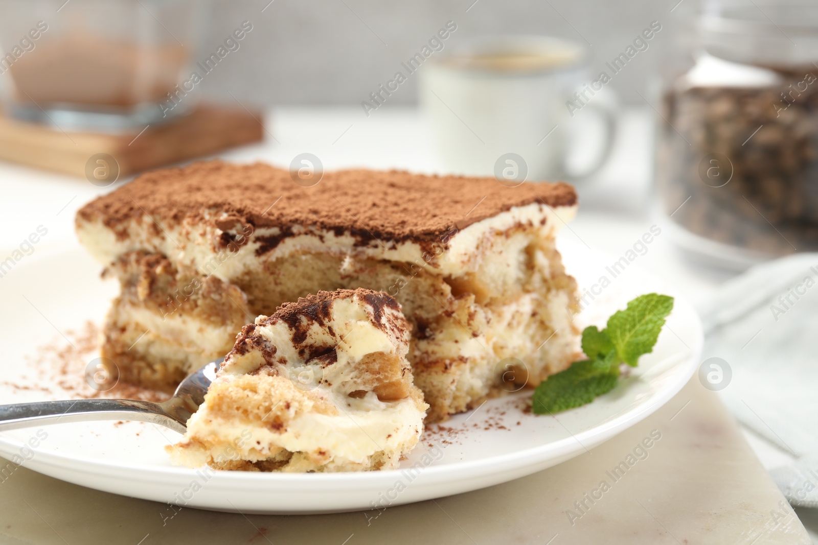 Photo of Piece of tasty tiramisu on table, closeup