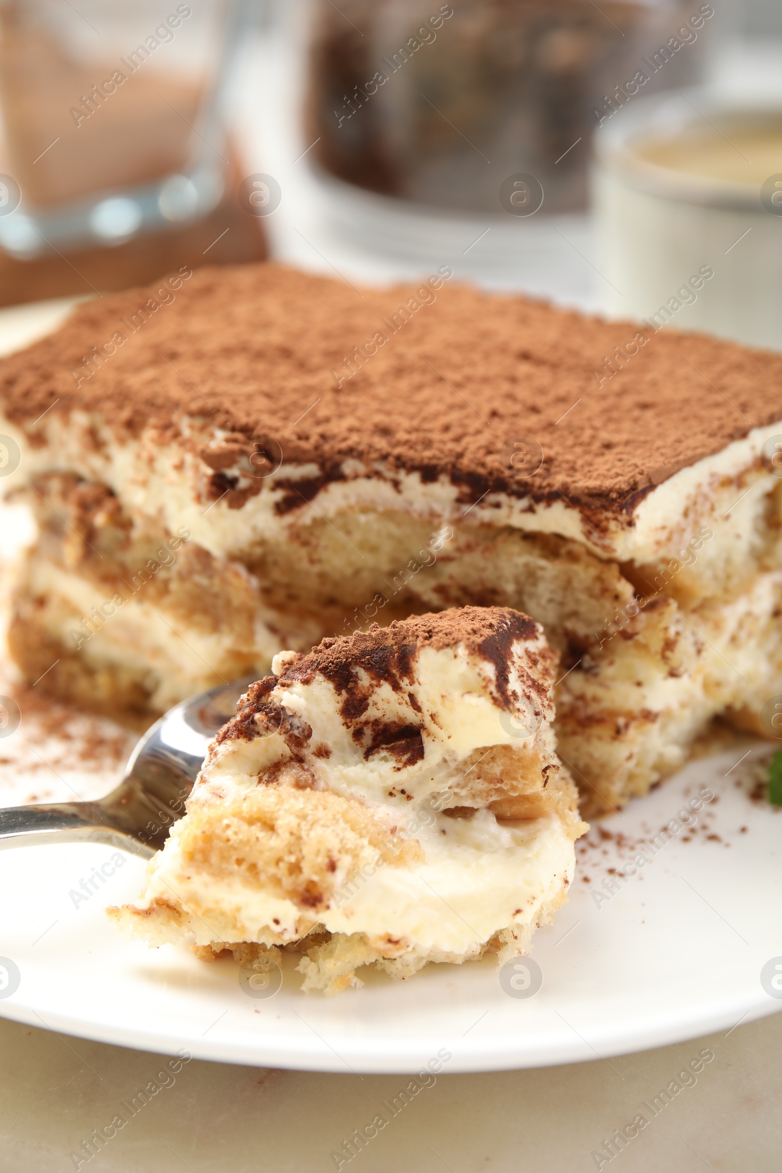 Photo of Piece of tasty tiramisu on table, closeup