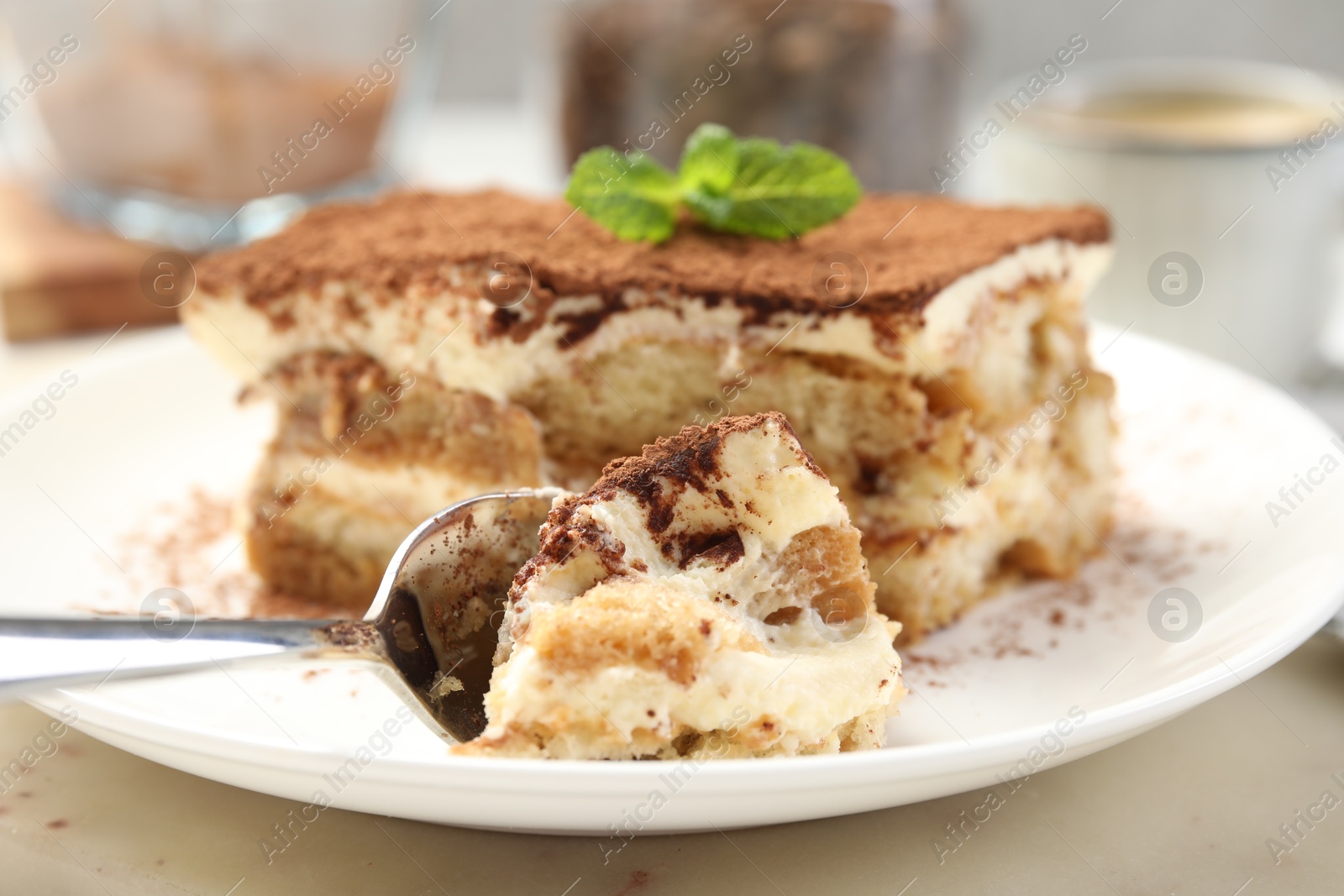 Photo of Piece of tasty tiramisu on table, closeup