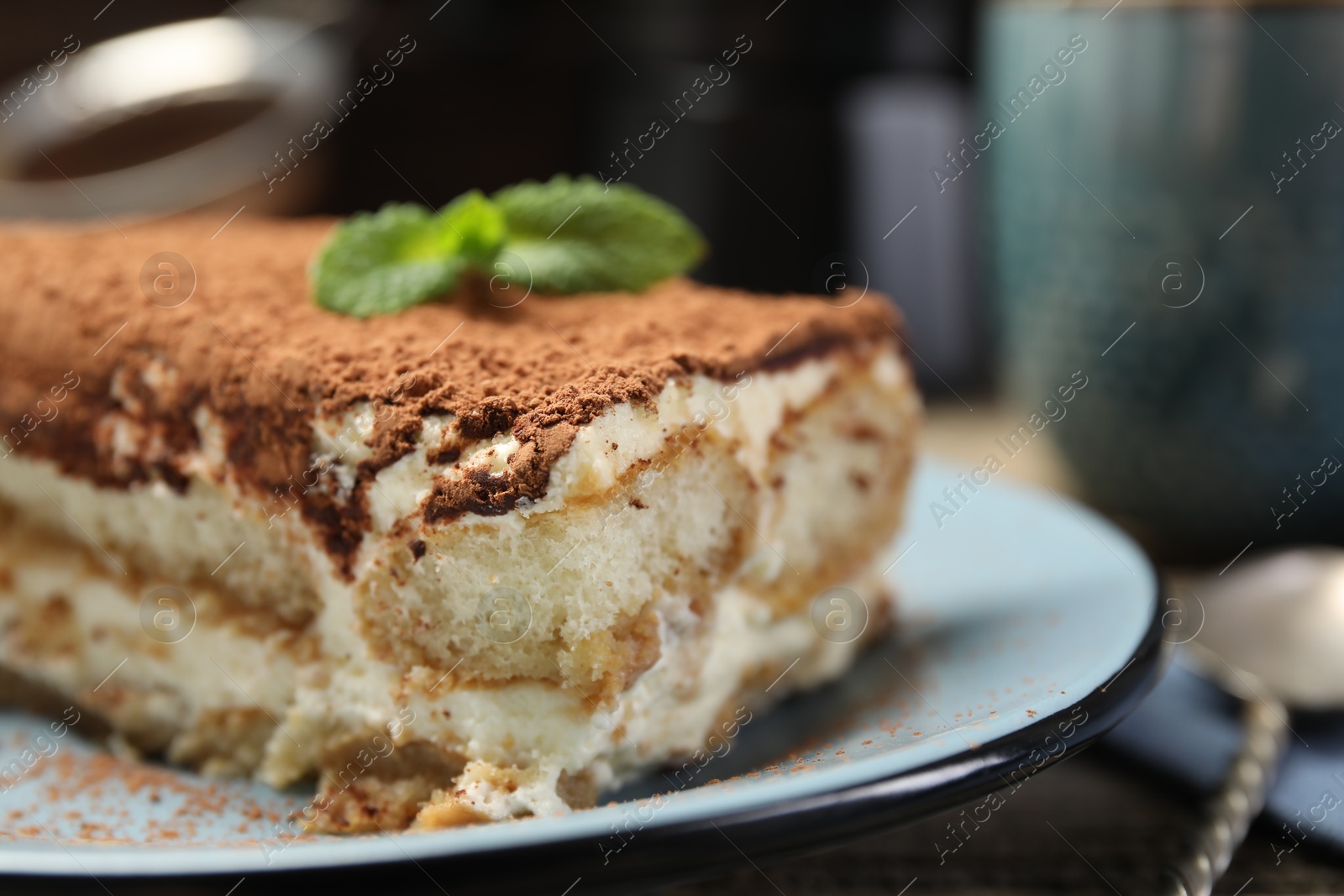 Photo of Piece of tasty tiramisu on table, closeup