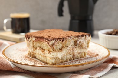 Photo of Piece of tasty tiramisu on table, closeup