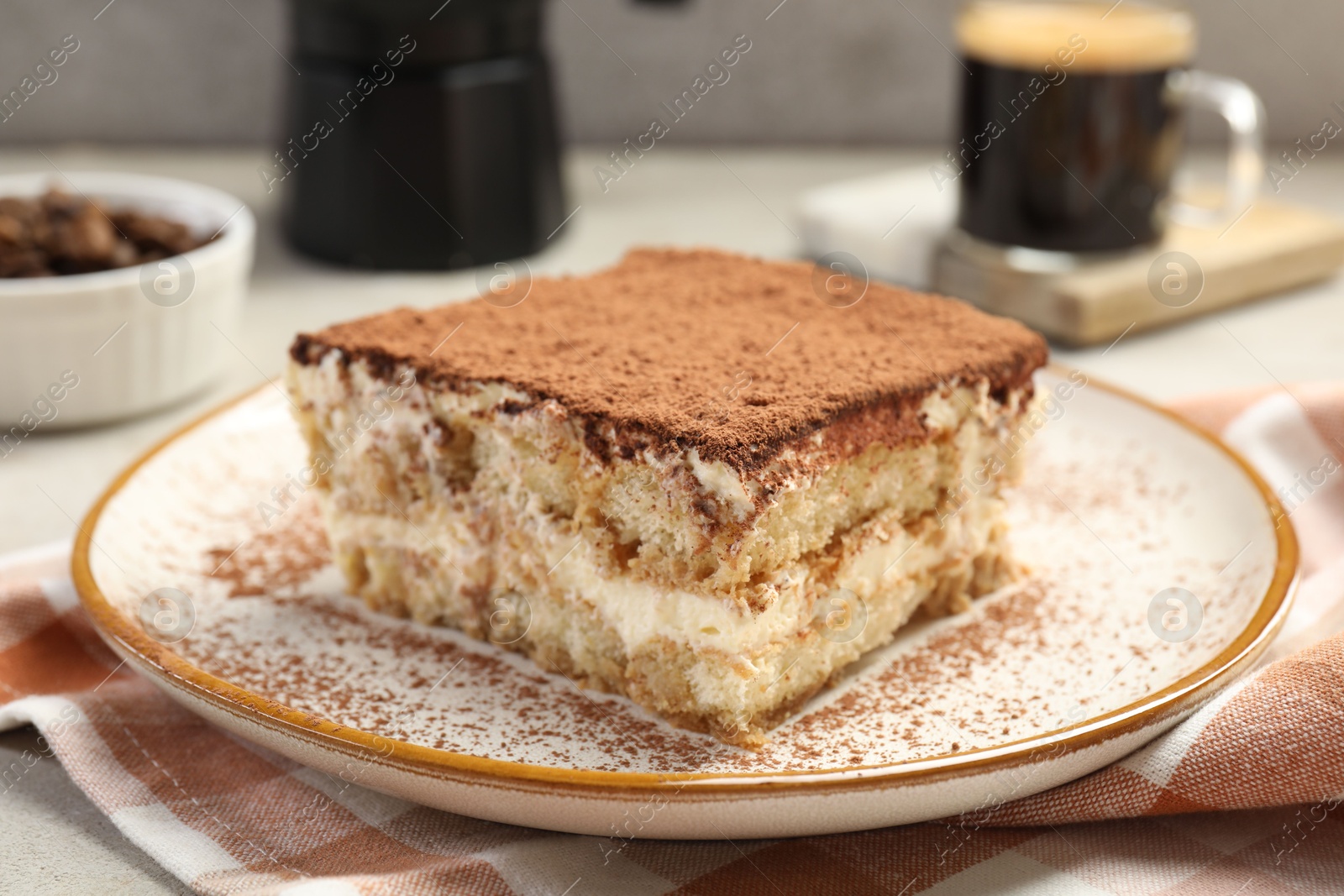 Photo of Piece of tasty tiramisu on table, closeup