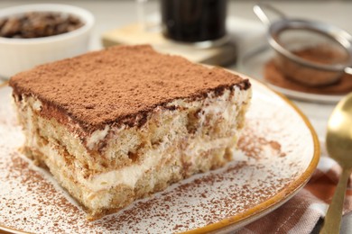 Photo of Piece of tasty tiramisu on table, closeup