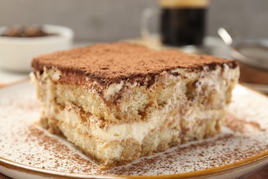 Photo of Piece of tasty tiramisu on table, closeup