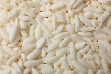 Photo of Wholegrain puffed rice as background, closeup view