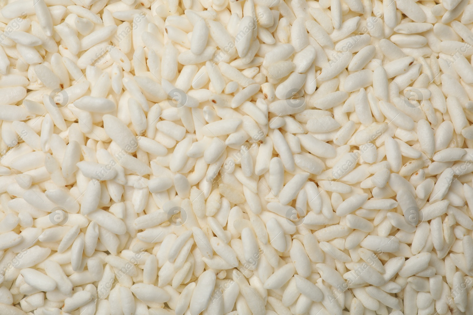 Photo of Wholegrain puffed rice as background, closeup view