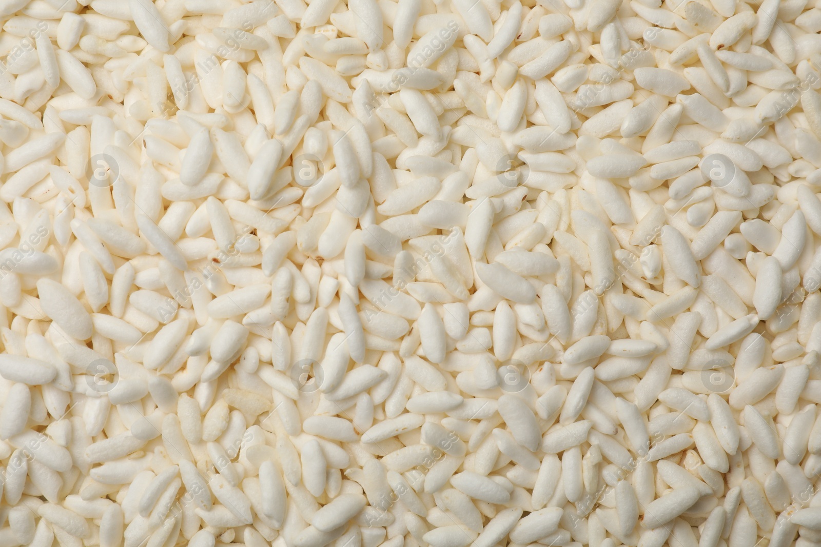 Photo of Wholegrain puffed rice as background, closeup view