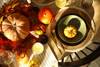 Photo of Stylish table setting with beautiful autumn decor in dining room, top view