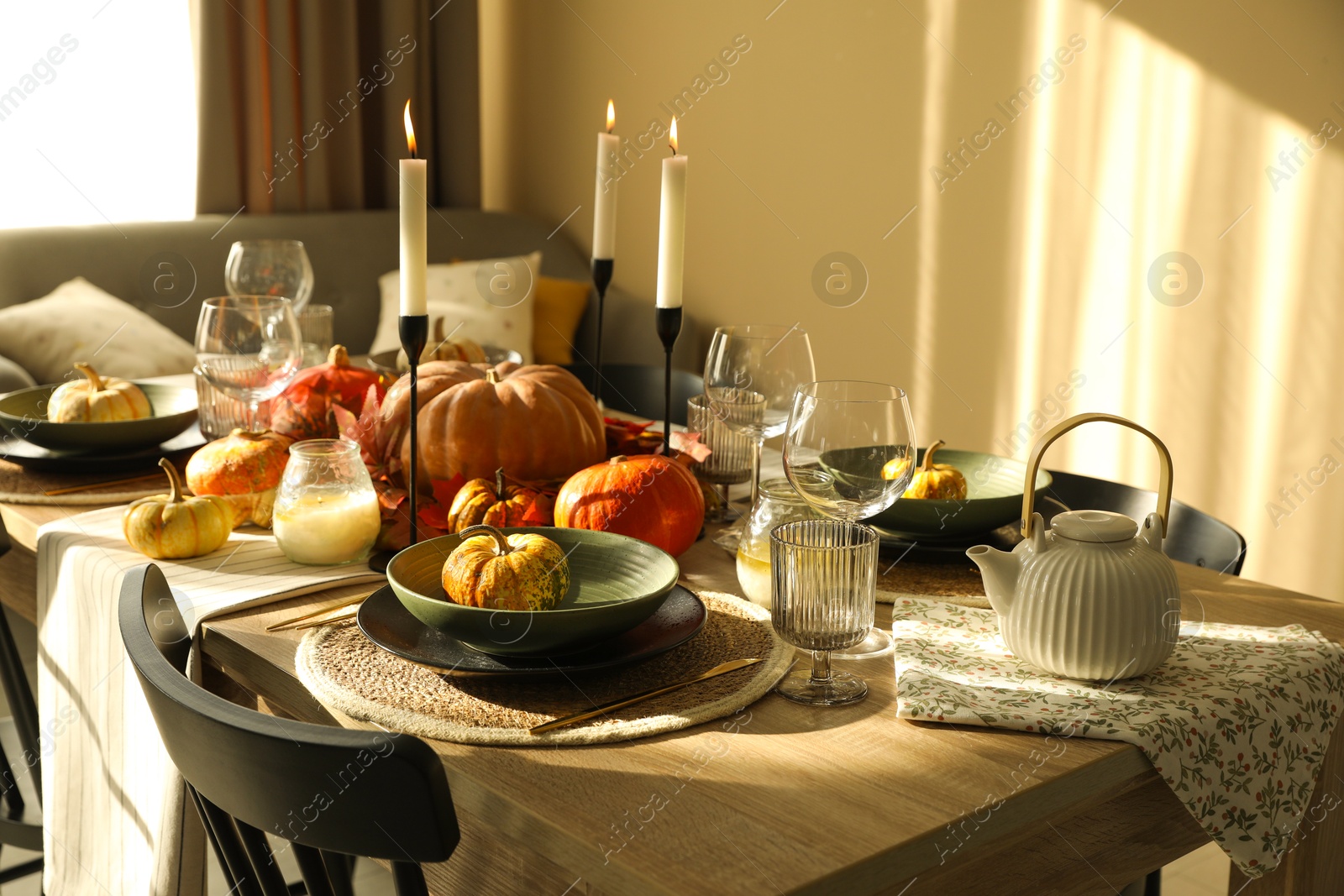 Photo of Stylish table setting with beautiful autumn decor in dining room