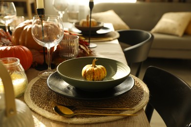 Photo of Stylish table setting with beautiful autumn decor in dining room