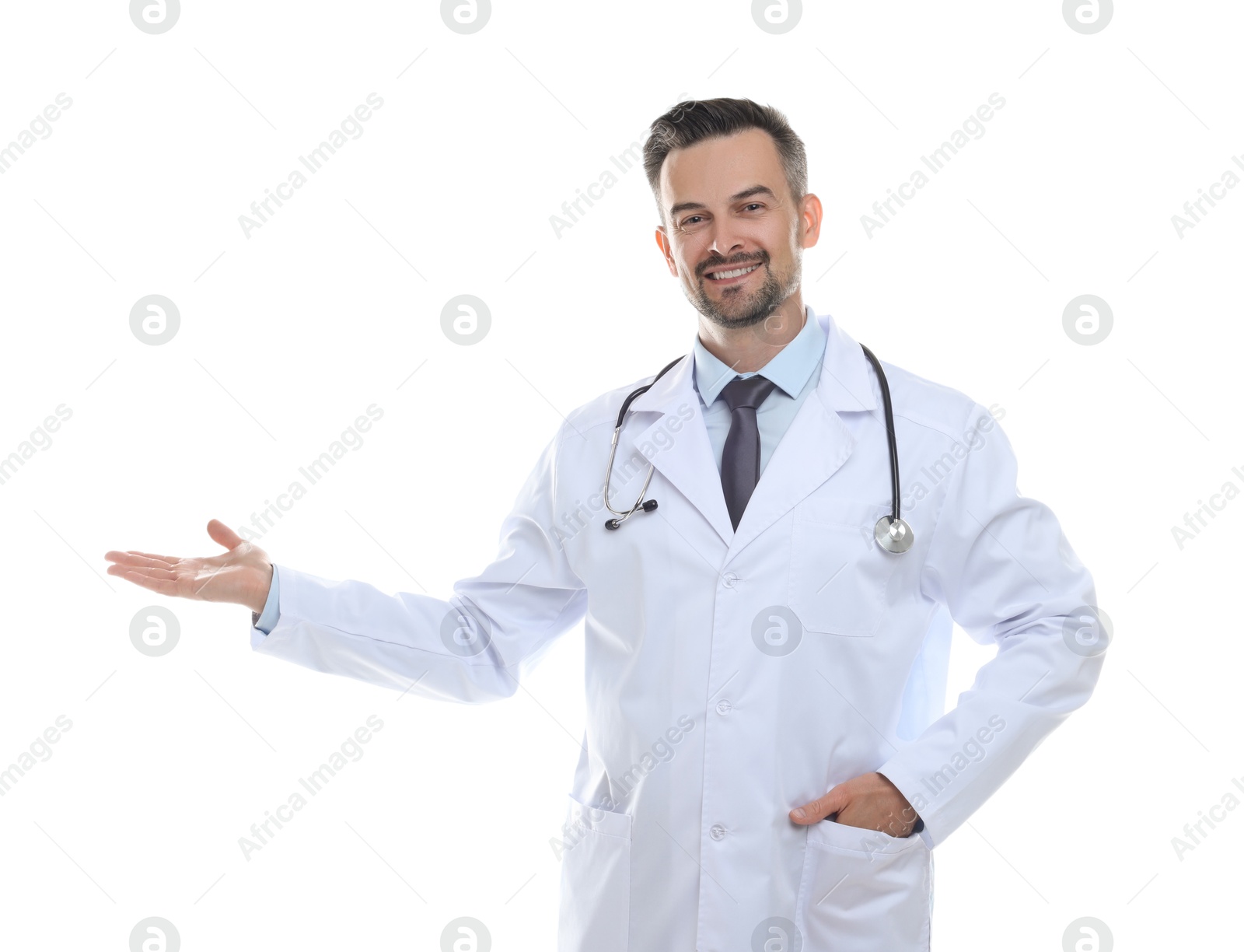 Photo of Smiling doctor with stethoscope pointing at something on white background