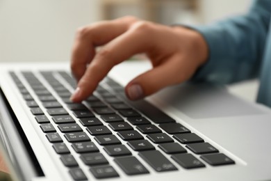 Photo of Businesswoman using laptop indoors, closeup. Modern technology