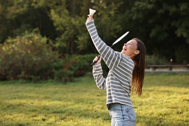 Photo of Young woman playing badminton racket in park