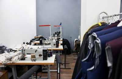 Photo of Sewing machines with spools of thread in professional workshop