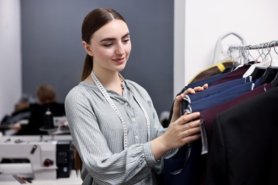 Photo of Atelier. Young woman working in professional workshop